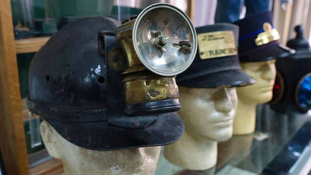 Miners' and railroaders' caps are part of the exhibit that stresses the human side of railroads and industry. 